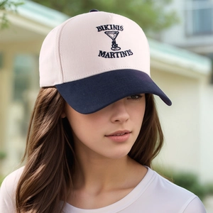 Detail of vintage embroidered baseball cap with navy brim and martini glass design
