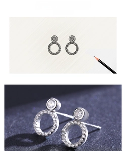 Macro detail of S925 silver round stud earrings featuring a solitaire and pavé zircon ring