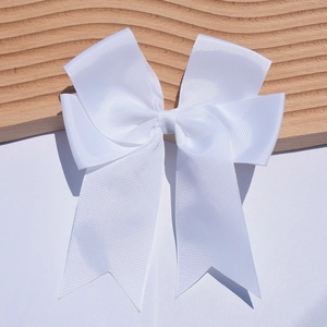 Close-up of a white 6-inch grosgrain ribbon bow hairpin with fishtail streamers