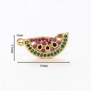 Detailed macro view of a 17mm gold watermelon charm with colorful inlaid zircons