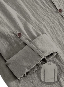 Detail of light gray linen shirt cuffs showing wood-like buttons and natural fabric texture