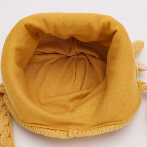 Close-up of bright yellow baby winter hat with thick knit texture and warm soft fabric lining