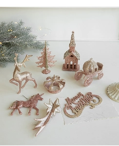Glittery rose gold and champagne reindeer ornaments on glowing pine branches