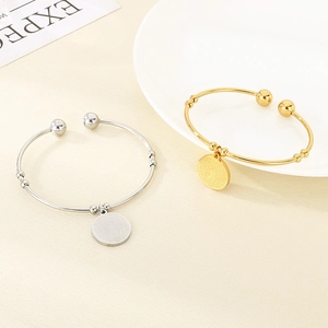 Minimalist 18K gold and silver open bangles with round cross pendant charms
