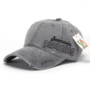 Detail of grey washed baseball cap showing Scenario planning embroidery and distressed finish