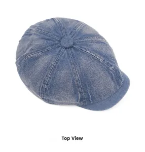 Top view of blue washed denim newsboy cap showing detailed stitching and fabric texture