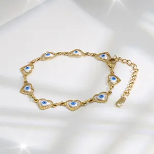Close-up of golden heart-shaped evil eye bracelet with adjustable lobster clasp