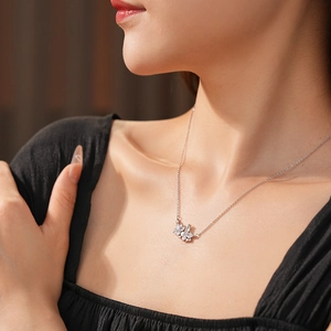 Détail du collier pendentif noeud argenté serti de zircons porté par un mannequin