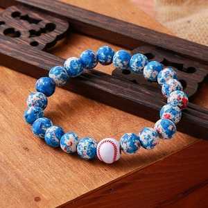 Detail of beaded bracelet with turquoise stones and white baseball-style accent bead