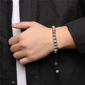 Detail of adjustable natural stone beaded bracelet with grey marble patterns on wrist