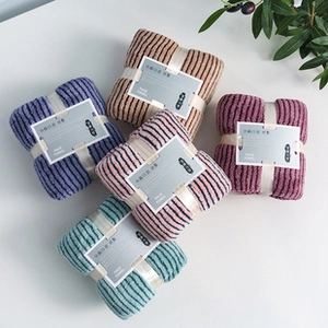 Macro view of five-color striped face towel set with knit texture and gift wrap