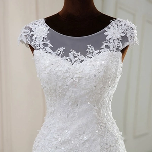 Elegant white lace wedding dress with floral appliques and sequin mesh neckline detail