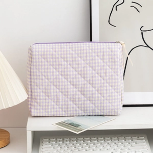 Close-up of purple and yellow checkered quilted toiletry bag with white ribbon puller