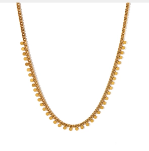 Detail of a gold choker necklace featuring multiple round sequins and delicate link chain