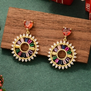 Detail of gold star and heart earrings with colorful zircon tassels on festive background
