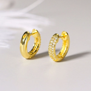 Close-up of gold-plated hoop earrings with micro-paved white zircon stones