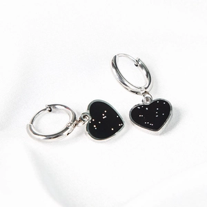 Elegant silver circle earrings with black heart charms featuring white dots on silk
