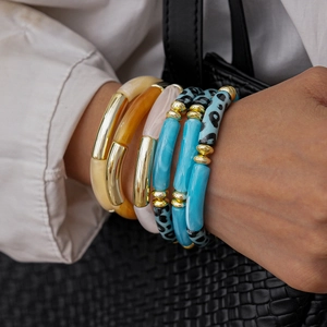Three-piece acrylic and metal stretch bracelet set with amber and marble patterns