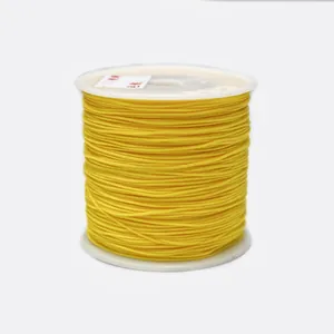 Detailed view of 0.8mm yellow braided cord on a white spool for jewelry making