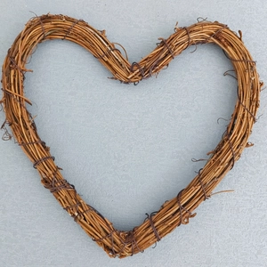 Macro view of a brown heart-shaped rattan wreath made of natural branches and fine wire