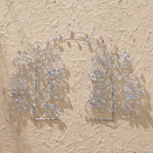 Luxurious bridal headband with handcrafted silver crystals and beads on textured background