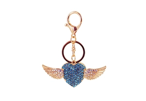 Detail of gold heart wing keychain with blue rhinestones and lobster clasp on white background