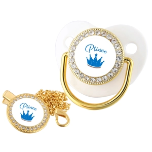 Detail of gold crown prince pacifier with crystal rhinestones and matching chain clip