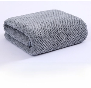 Detailed view of grey waffle weave coral fleece towel showing soft honeycomb texture