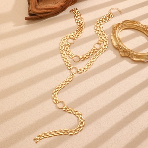 Close-up of golden multi-layer hip-hop tank chain with ring pendant and lobster clasp