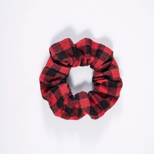Detail of red and black plaid fabric texture on a soft cotton hair scrunchie