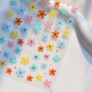 Macro shot of 5-petal flower nail stickers with crystals on card LA-344 in pastel colors