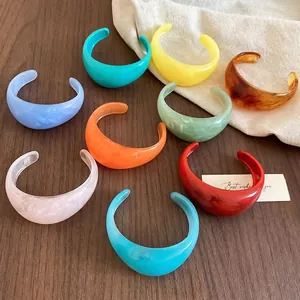 Minimalist wide resin bangles in multiple marble colors with a translucent finish