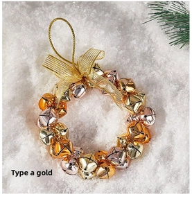 Detailed view of a Christmas bell wreath with a gold mesh bow on snowy background