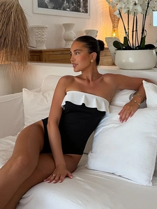 Détail d'un maillot de bain bustier noir et blanc avec volants élégants au décolleté