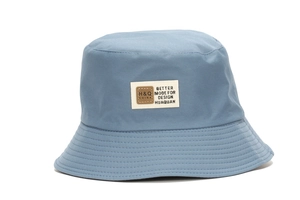 Detail of light blue sun hat fabric texture and rectangular decorative label