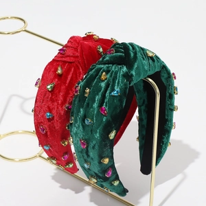 Detail of red and green velvet headbands decorated with colorful faux gemstones