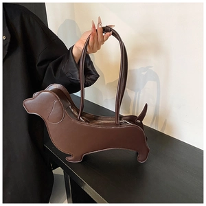 Close-up of the brown dachshund shaped leather shoulder bag with a metal zipper
