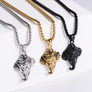 Three Ganesha pendant necklaces in silver, gold, and black steel on box chains