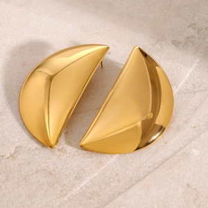 Polished gold moon crescent stainless steel stud earrings on a natural stone surface
