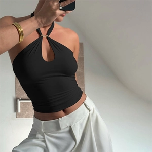 Detail of black halter top featuring a gold metal ring connector and ribbed fabric texture