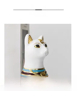 Close-up of Bastet cat statue detailing golden resin carvings and colorful neck patterns