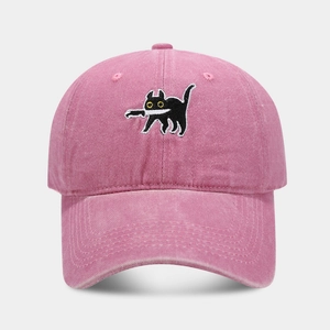 Close-up of a pink washed cotton baseball cap with a black cat holding a knife embroidery