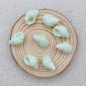 Detailed view of mint green spiral seashell ceramic beads for handmade DIY jewelry crafting