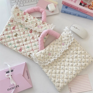 Detail of quilted laptop sleeve with cute bear print, lace trim and soft pink handles