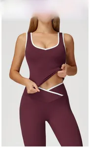 Detail of dark purple red yoga set with white contrast piping and backless V-neck design