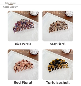 Detail view of acetate hair claws in blue-purple, floral gray, red, and tortoiseshell