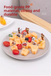 Close-up of food-grade PP animal and car fruit picks on fresh melon in a white plate
