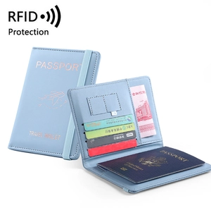 Detail view of light blue PU leather RFID passport wallet with card slots and elastic strap