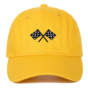 Close-up of checkered racing flag embroidery on a bright yellow twill cotton baseball cap