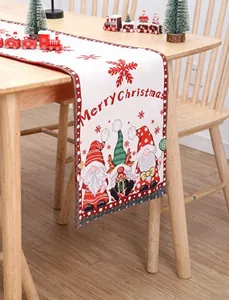 Table runner with festive Christmas gnomes and red snowflakes on a wooden table decoration